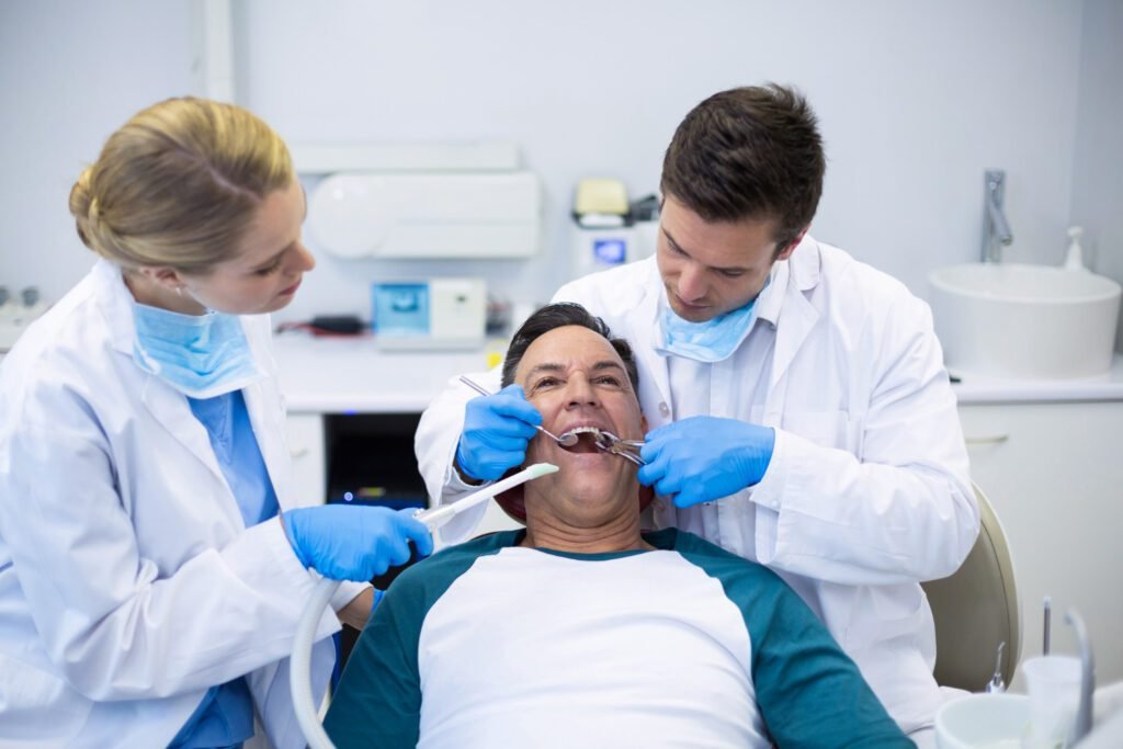 Hygienist gently removing tartar during a teeth cleaning procedure
