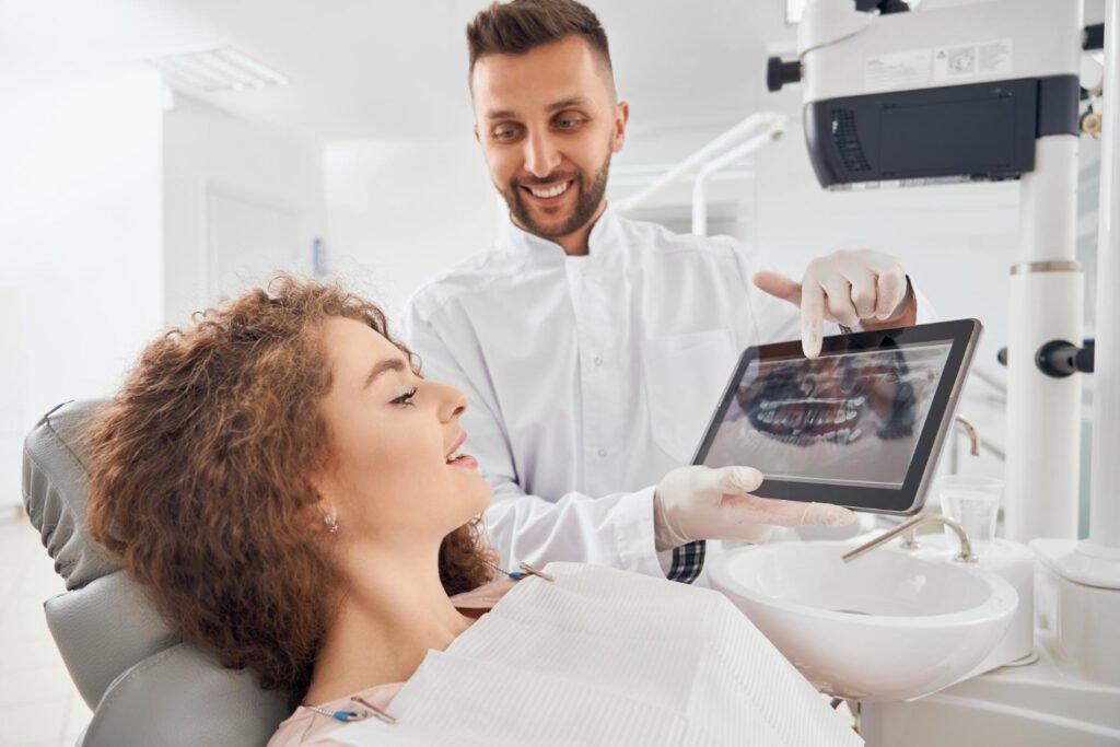 Dentist using intraoral camera to examine patient’s back teeth