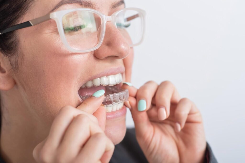 Patient putting the Invisalign in her teeth