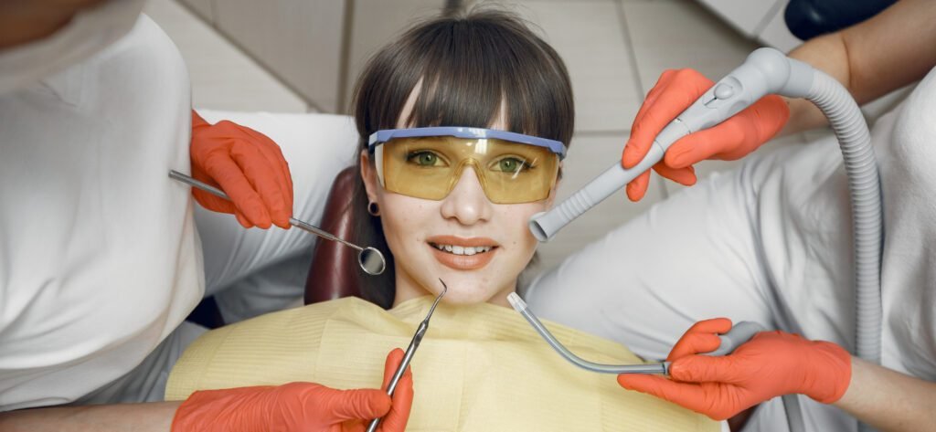 Child wearing VR goggles during dental treatment, relaxed and smiling.
