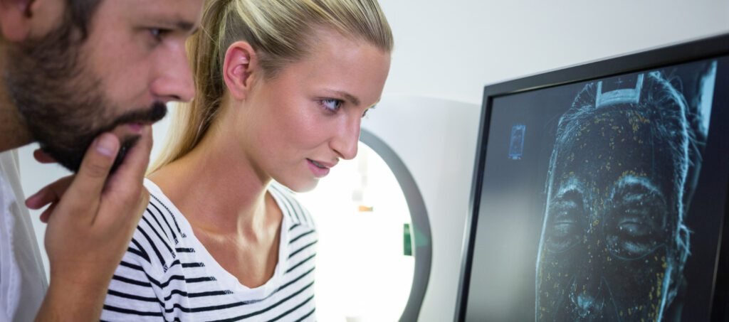 Digital facial analysis showing golden ratio grid over patient's photo